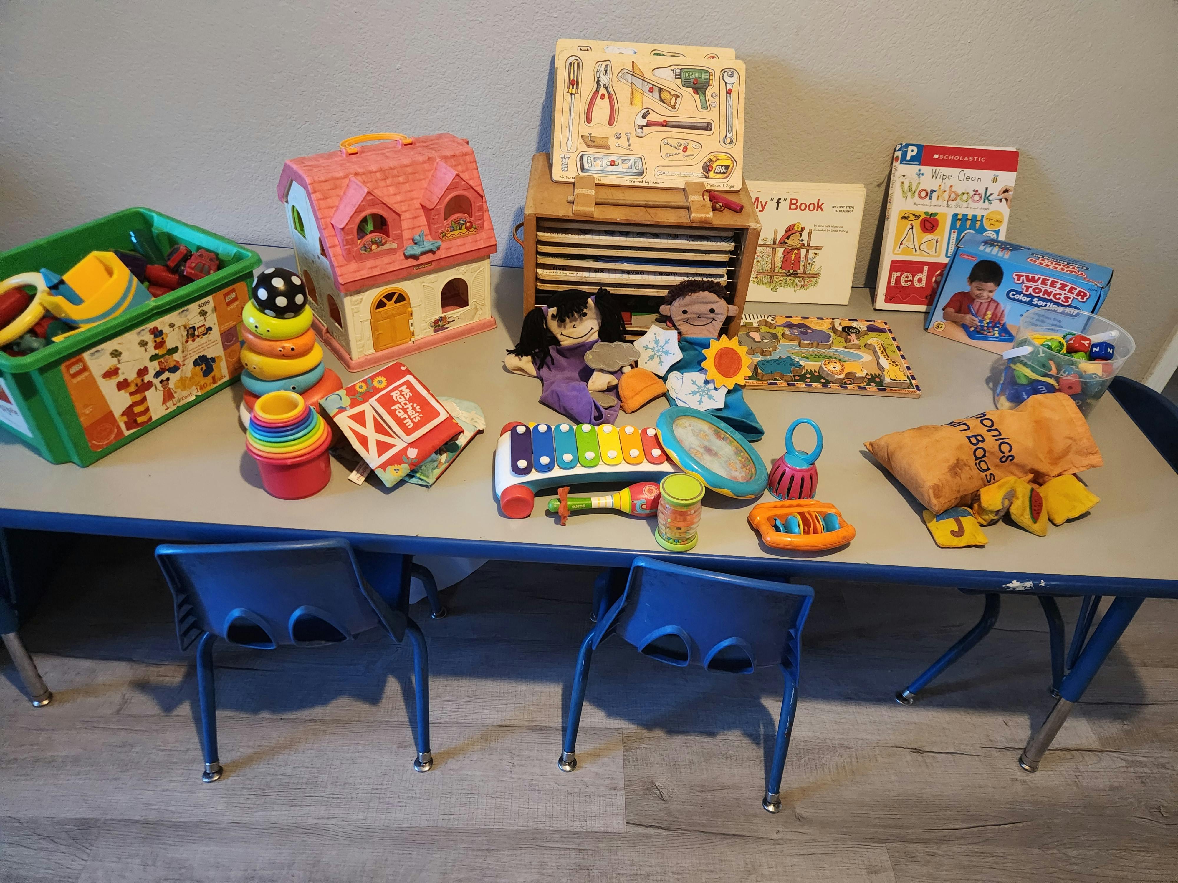 Top view of a table with assorted children's toys and books