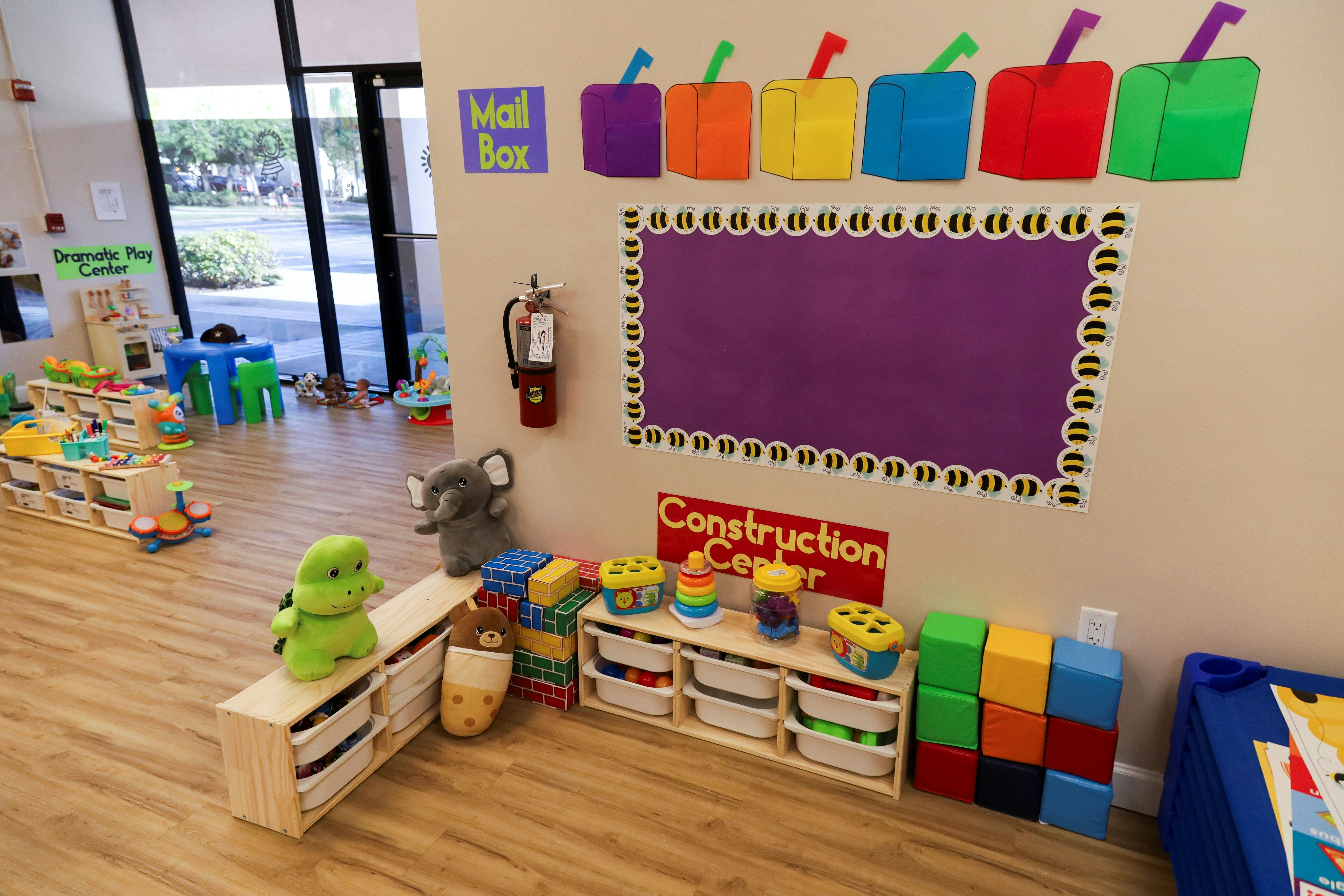 Playroom with toys, shelves, and a purple bulletin board