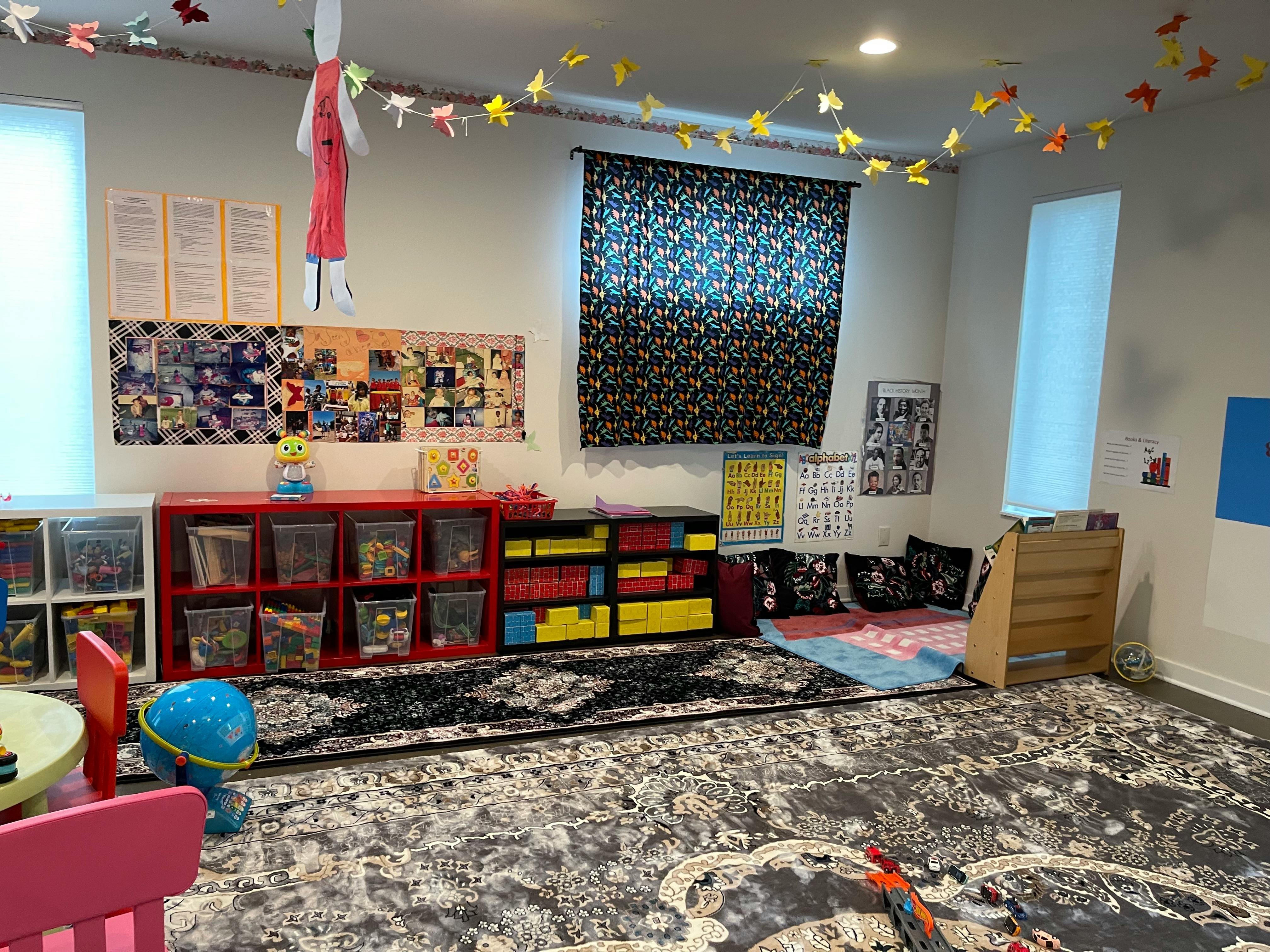 Children's playroom with storage bins, rugs, and decorations