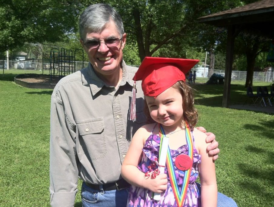 Person and child in graduation cap and medal