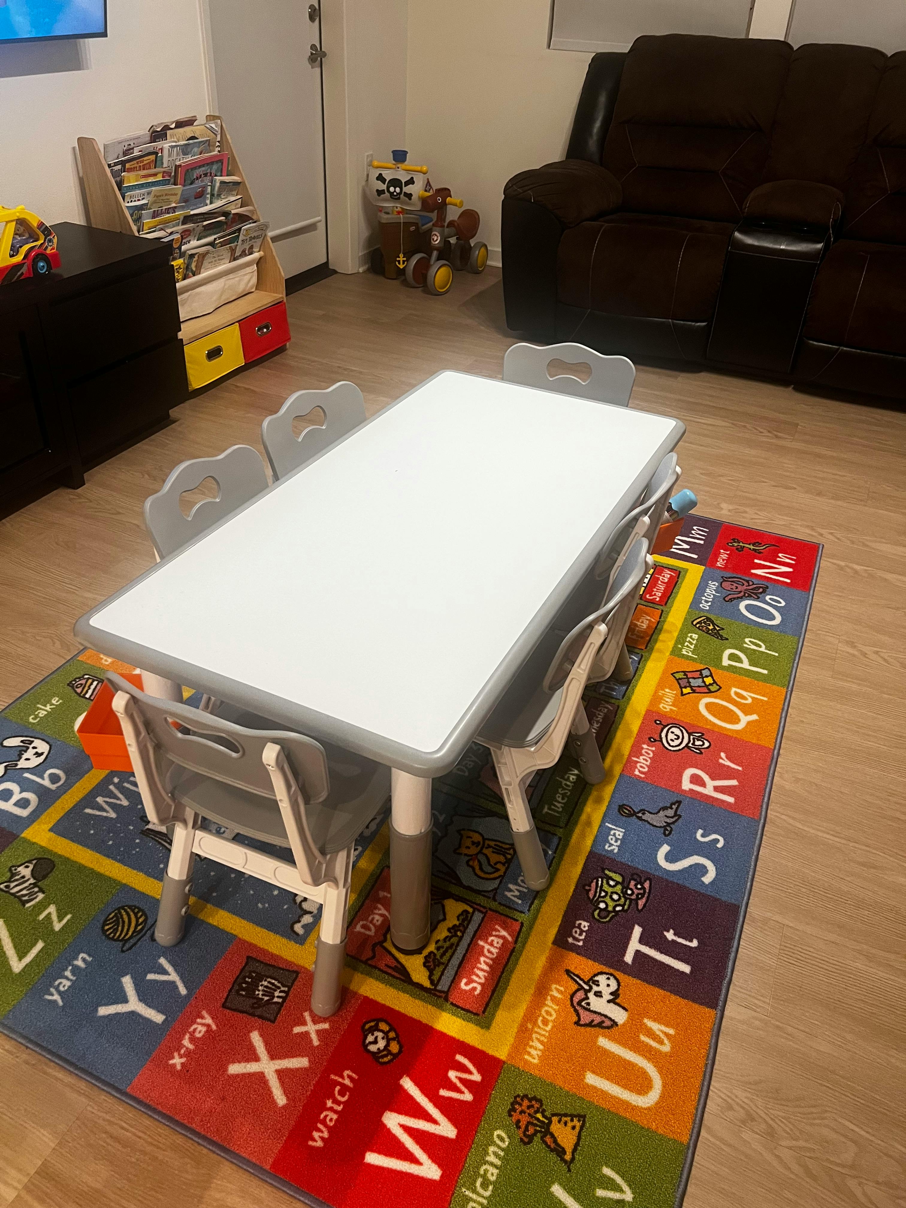 Children's table and chairs on an alphabet rug