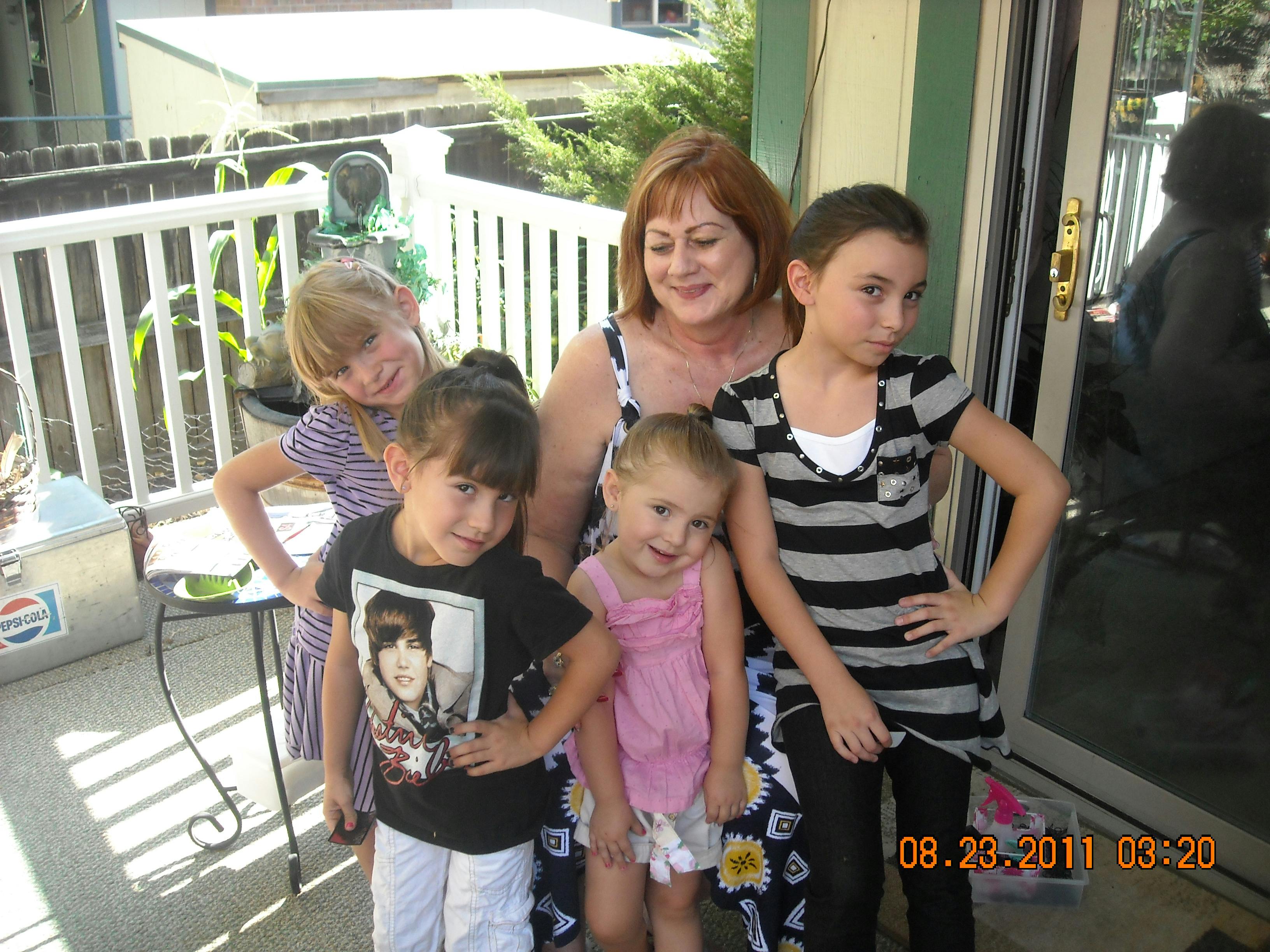 Adult and four children posing together