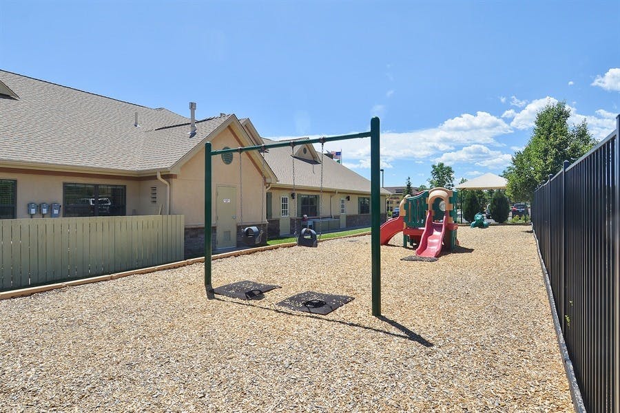 Empty playground with swing set and slide structure