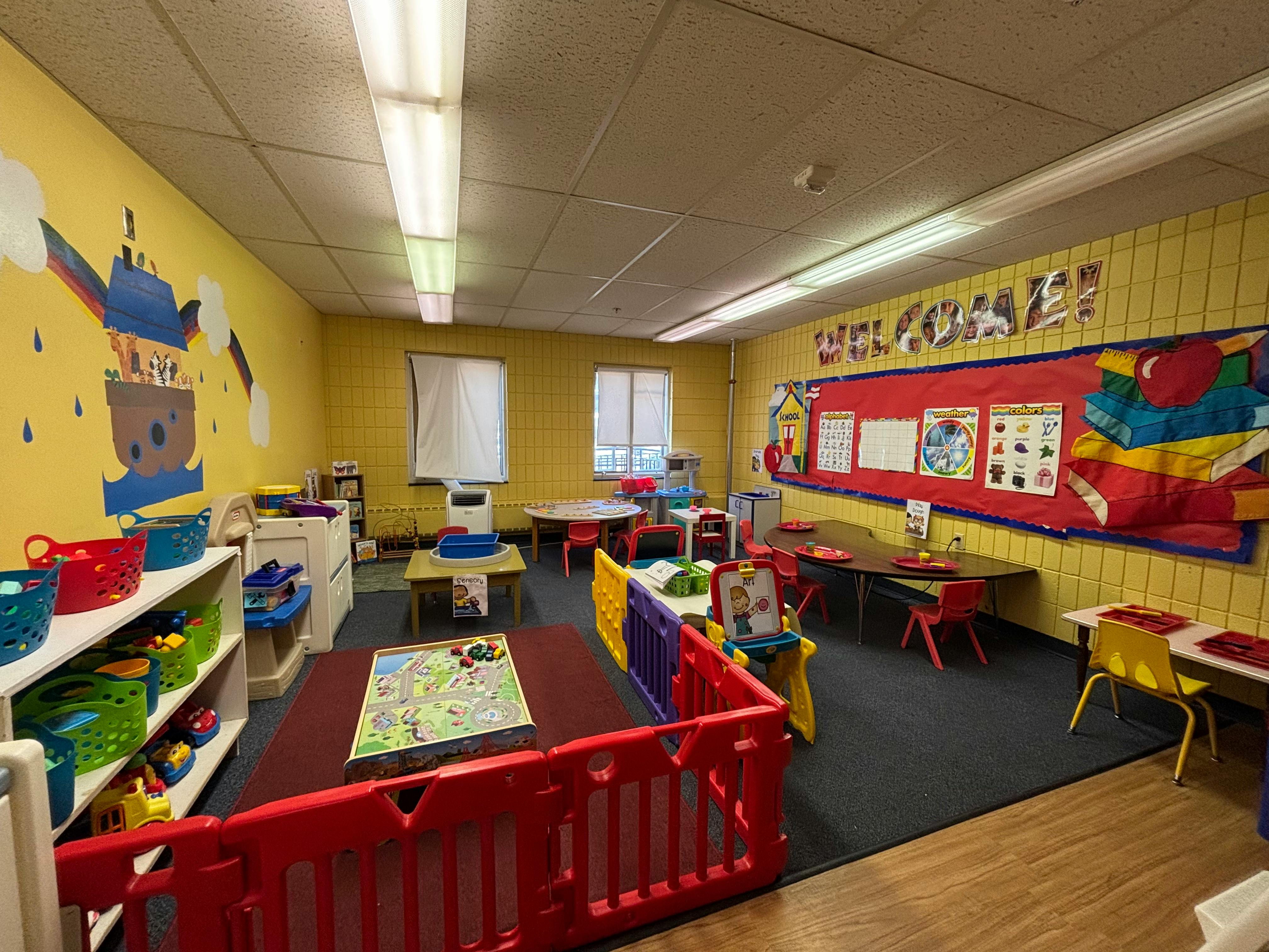 Colorful preschool classroom with learning posters and toy play areas