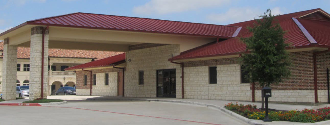 Building with a red roof and a covered entrance