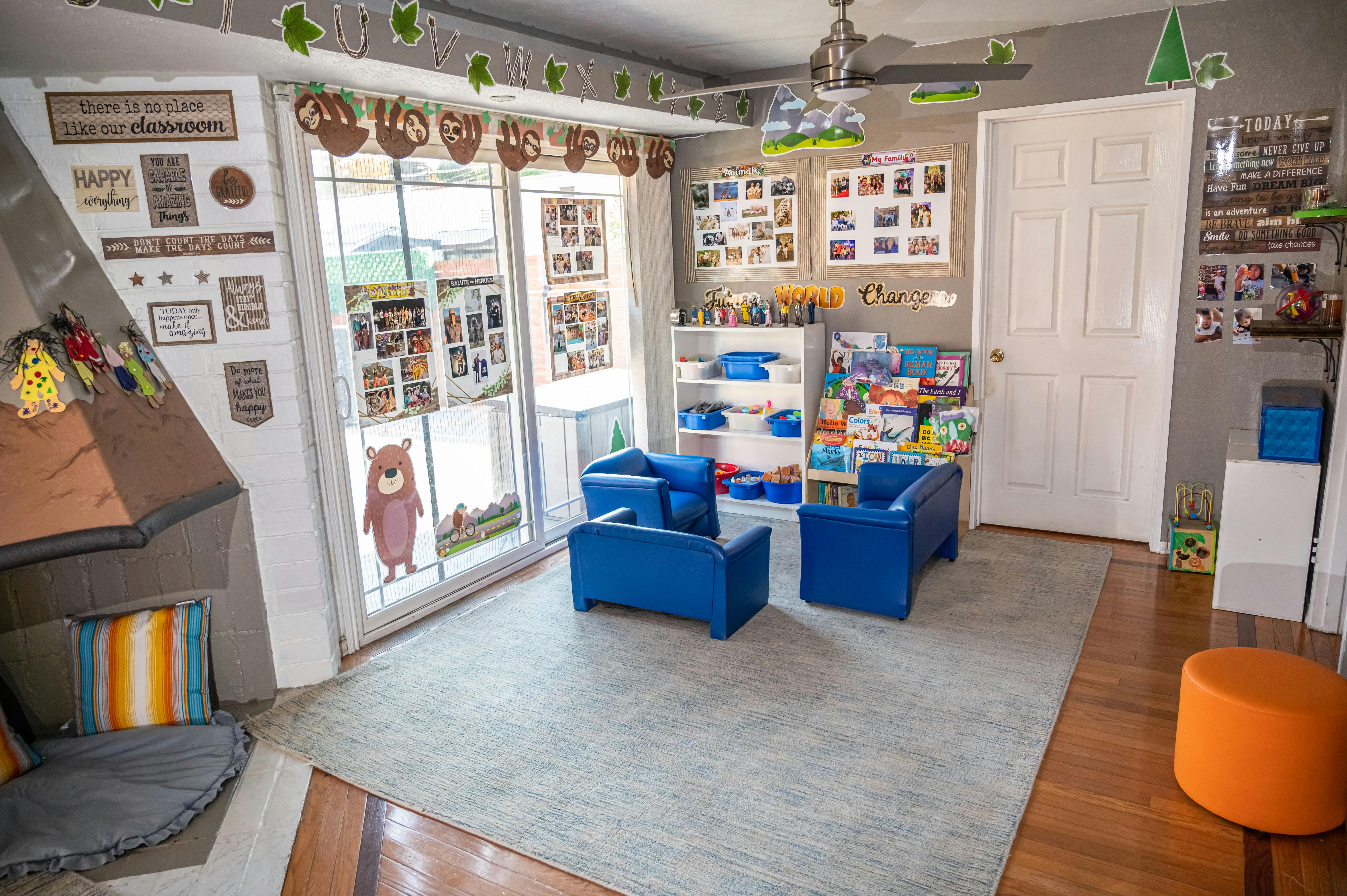 Classroom interior with small blue chairs bookshelves and learning decorations