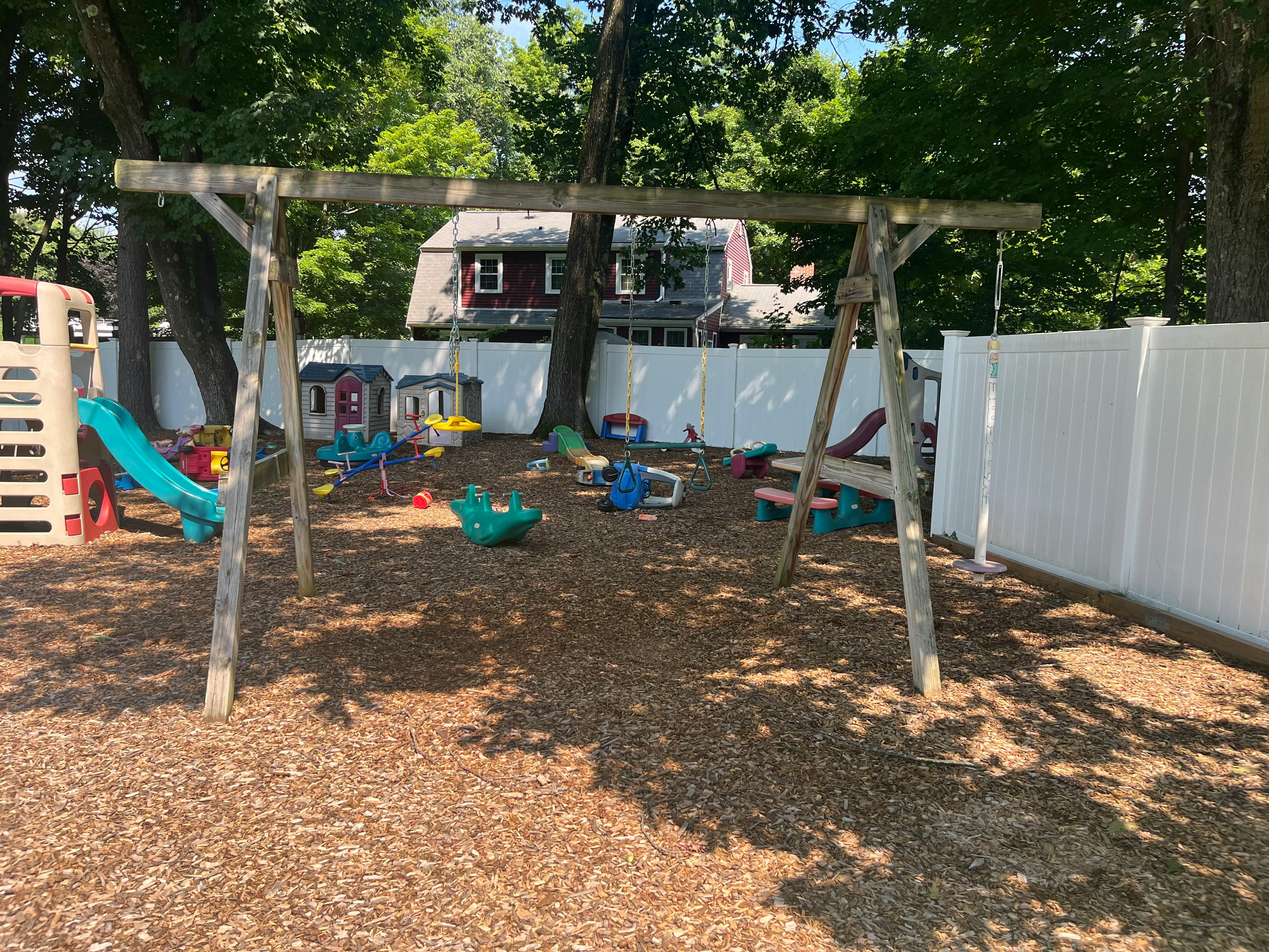 Playground with swing set, slide, and various play equipment