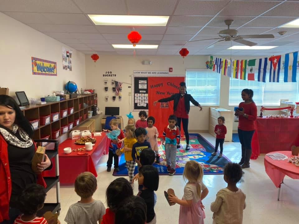 Adults and children gathered in a classroom