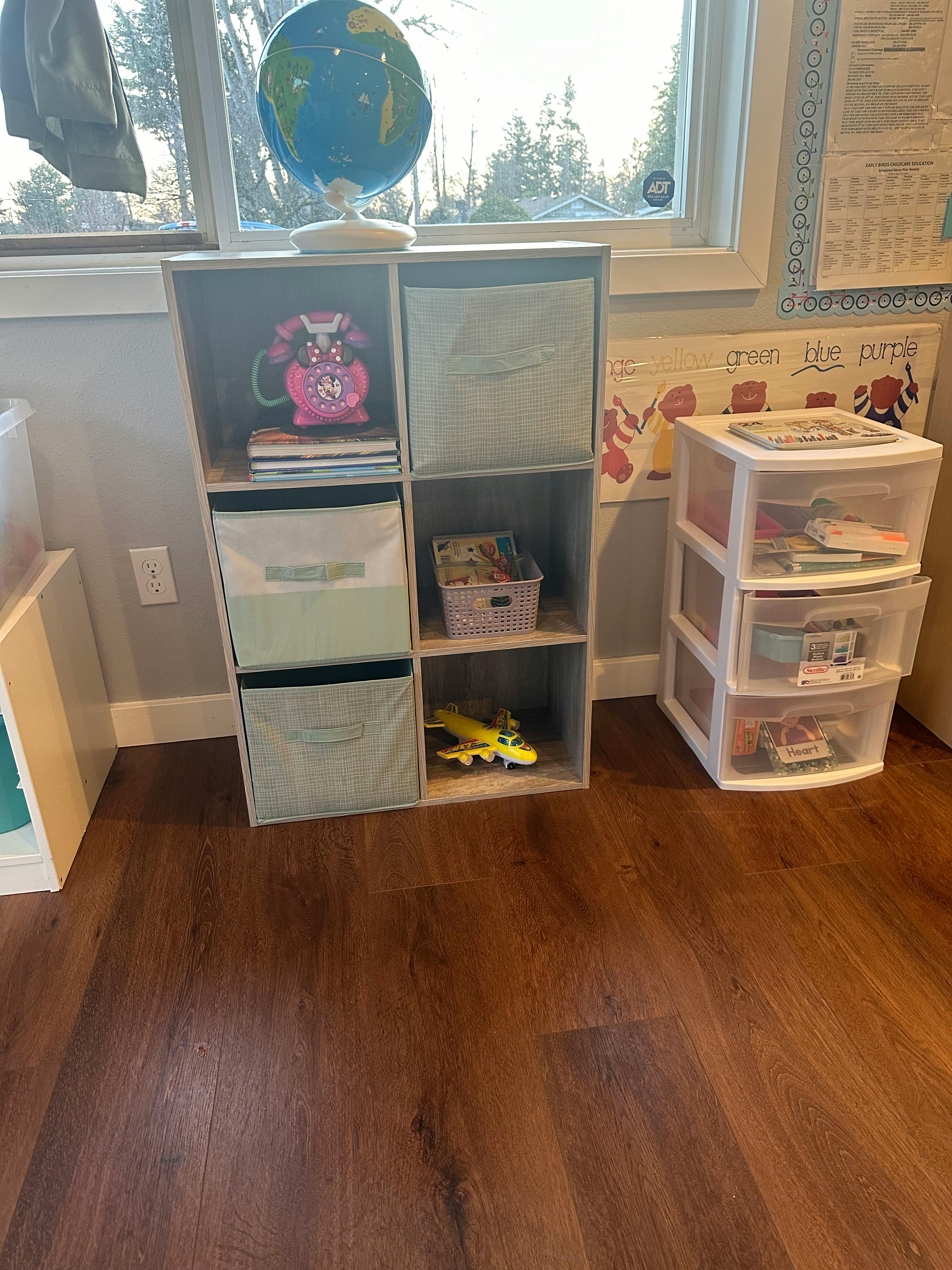 Storage cubes with a globe on top next to a plastic drawer unit