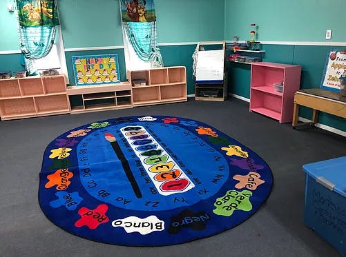Classroom with a blue rug featuring a paint palette design