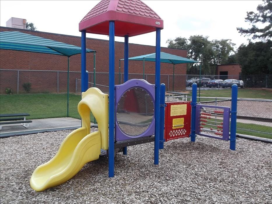 Colorful playground structure with yellow slide and activity panels