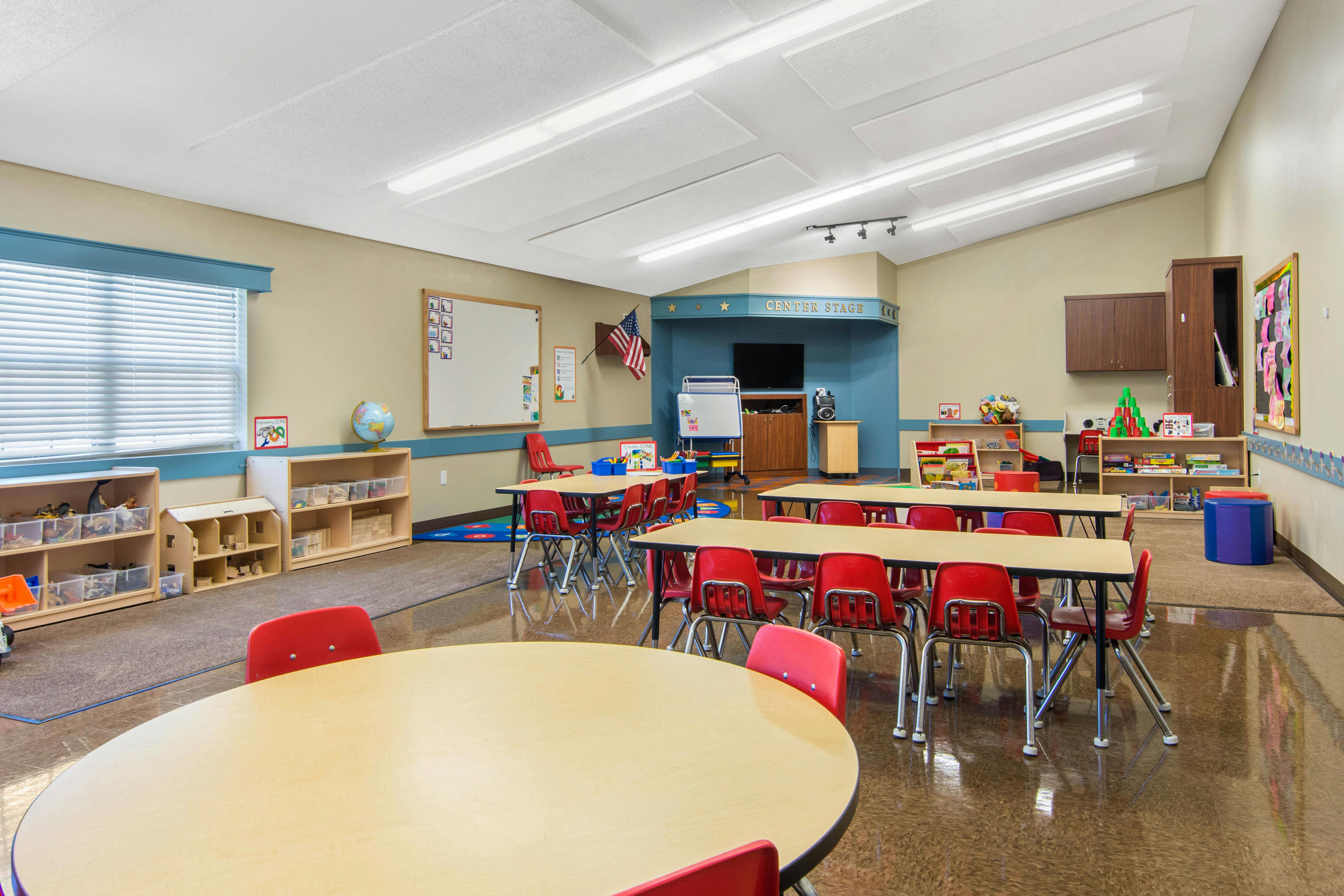 Classroom with child-sized tables and chairs and activity centers