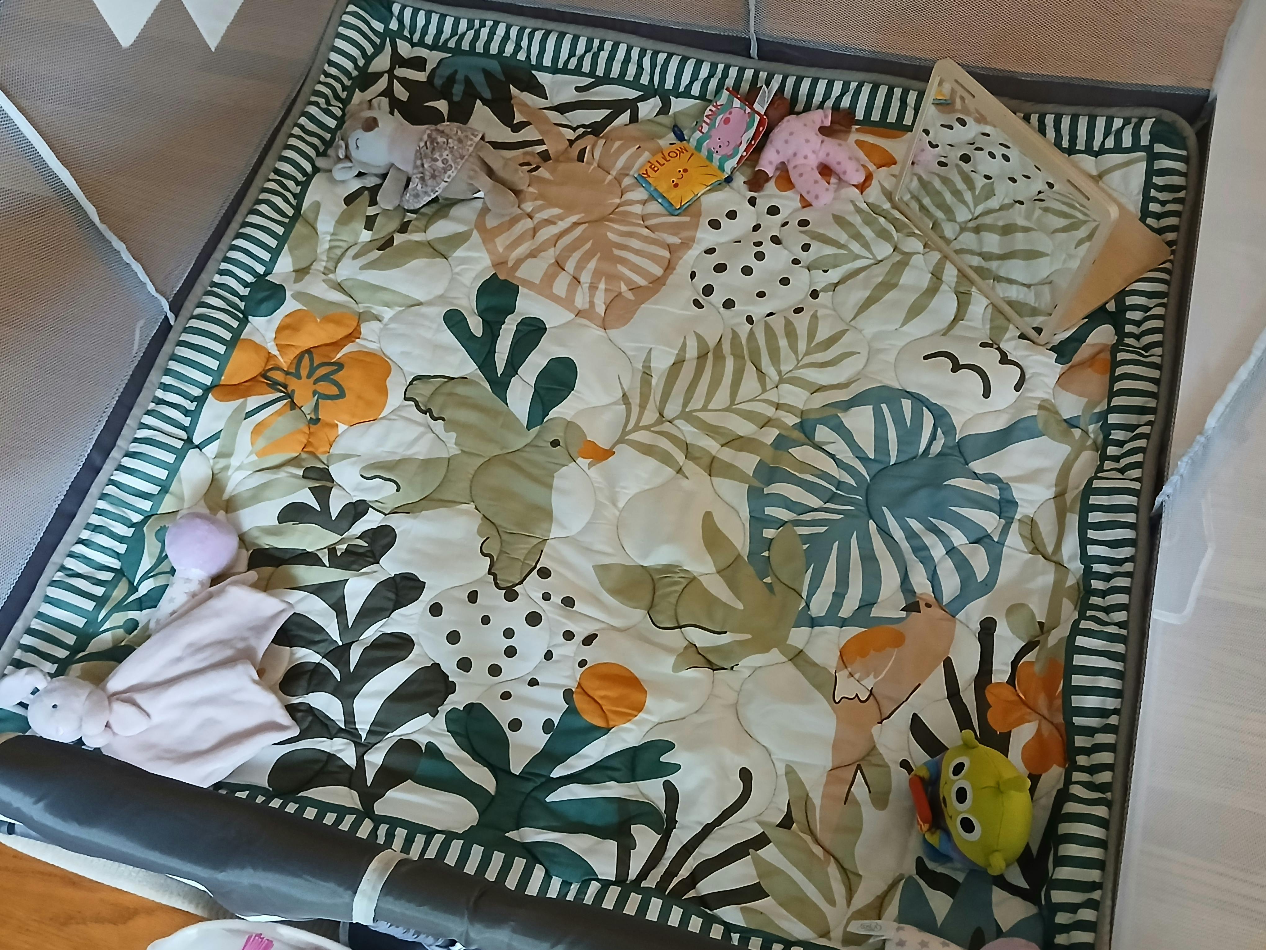 Baby play mat with botanical patterns and various toys