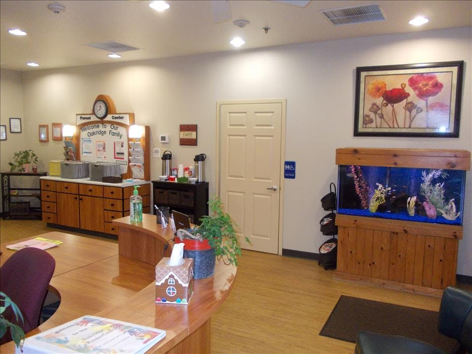 Lobby area with a welcome desk, coffee station, door, and a large fish tank