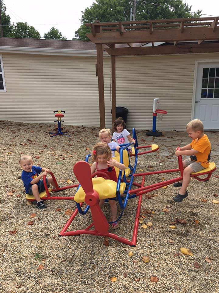 Children playing on a playground seesaw