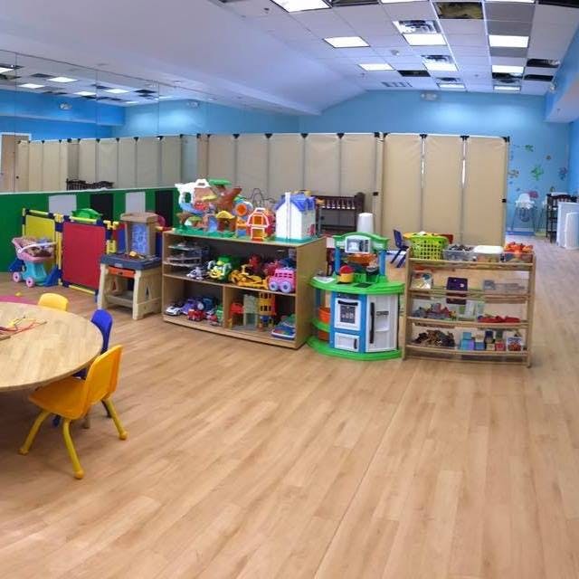 Playroom with toys on shelves and a small table with chairs