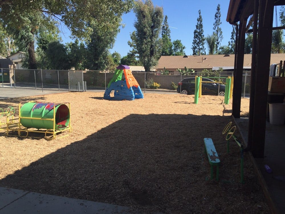 Playground with a green tunnel and a colorful climbing structure