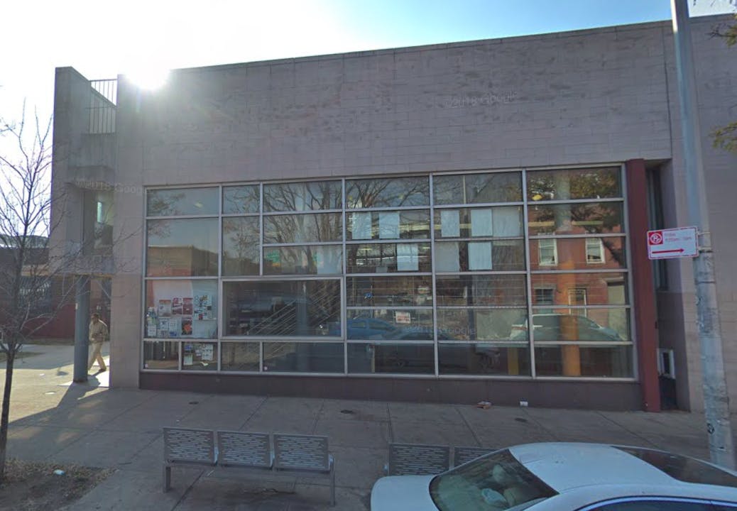 Building with large windows and a car parked in front