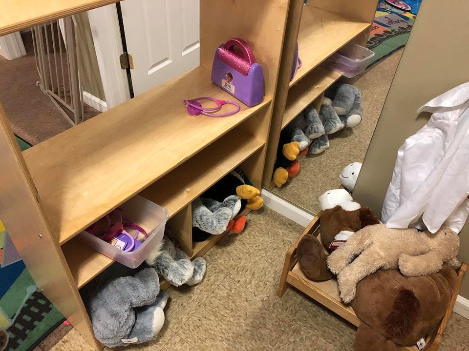 Wooden shelves with toys and stuffed animals