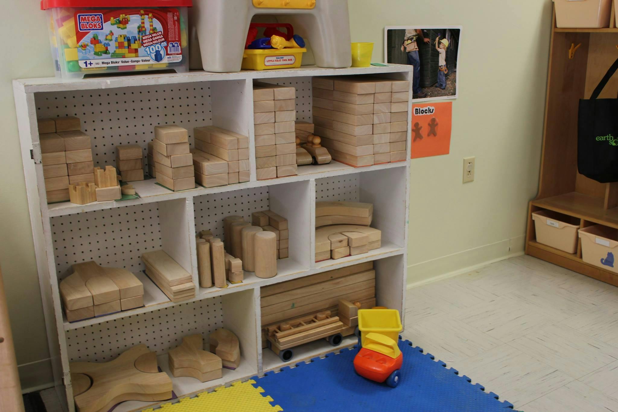 Shelves filled with wooden blocks and toys in a classroom