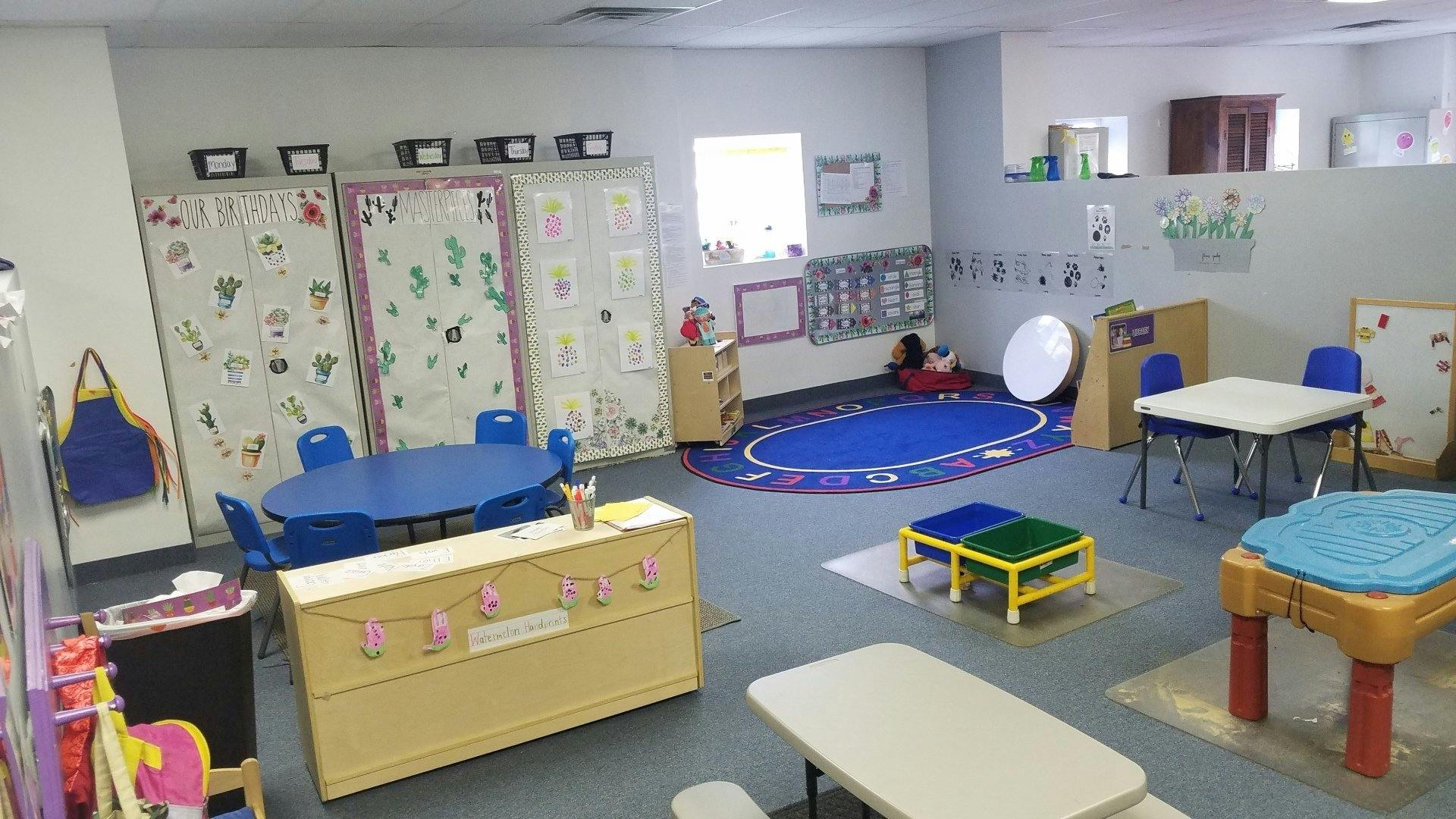 Empty classroom with small tables and chairs