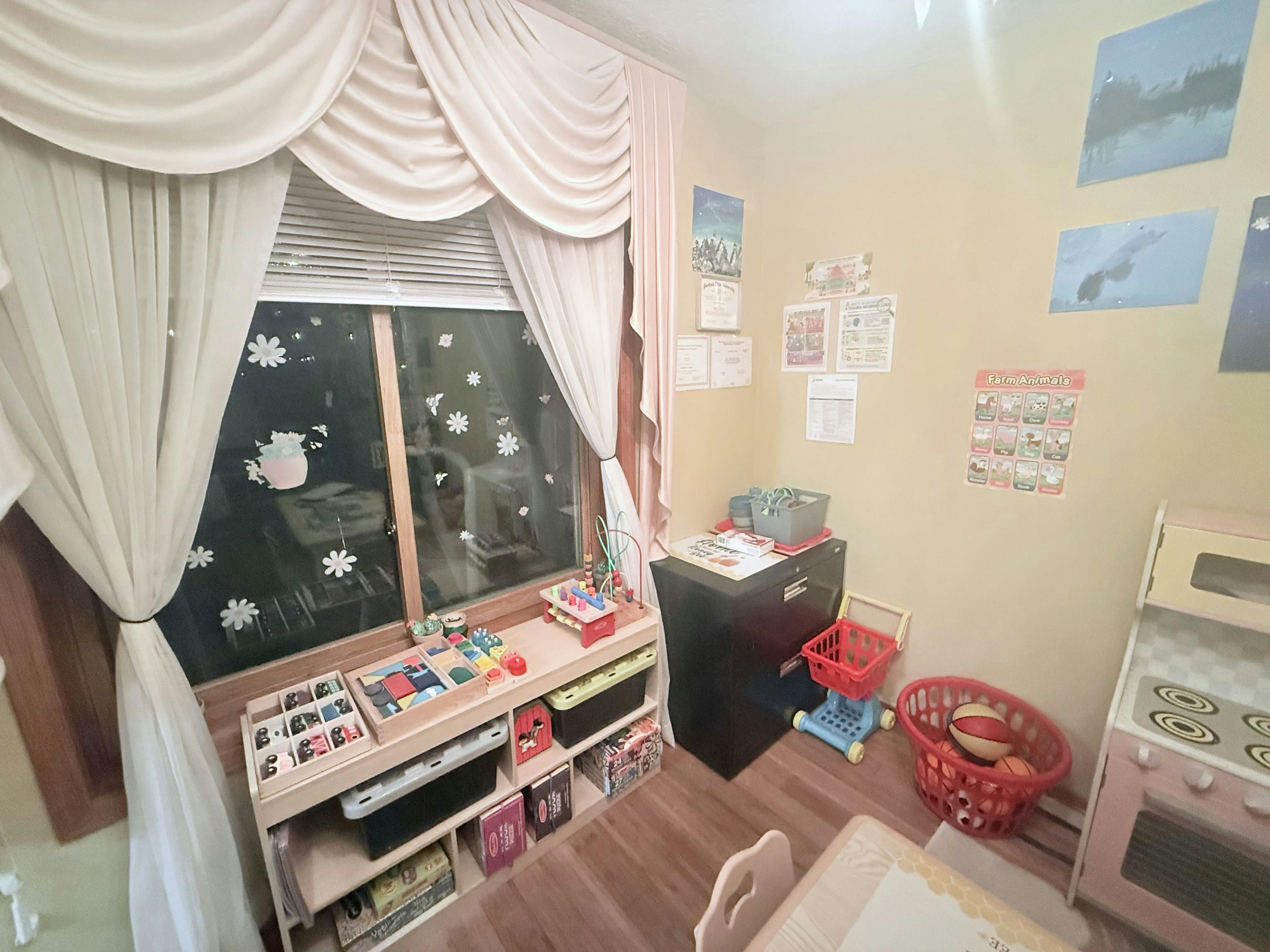 Playroom with children's toys, storage shelves, and a farm animals poster