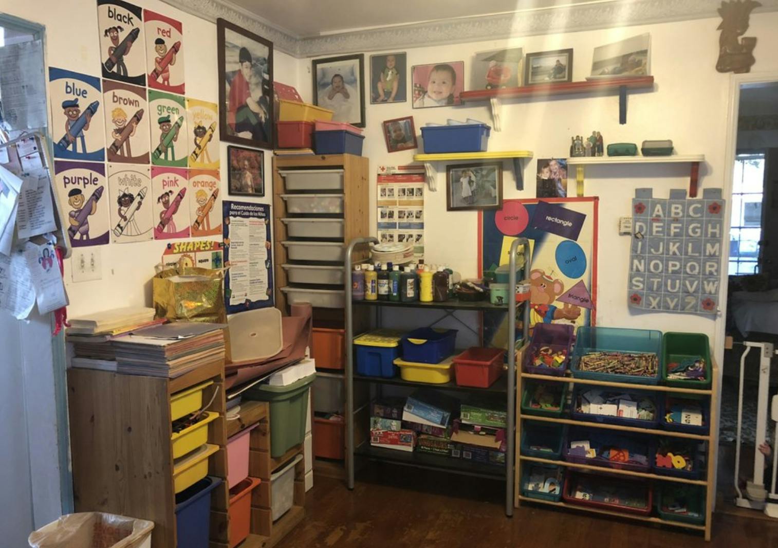 Classroom with shelves, storage bins, and artwork on the walls