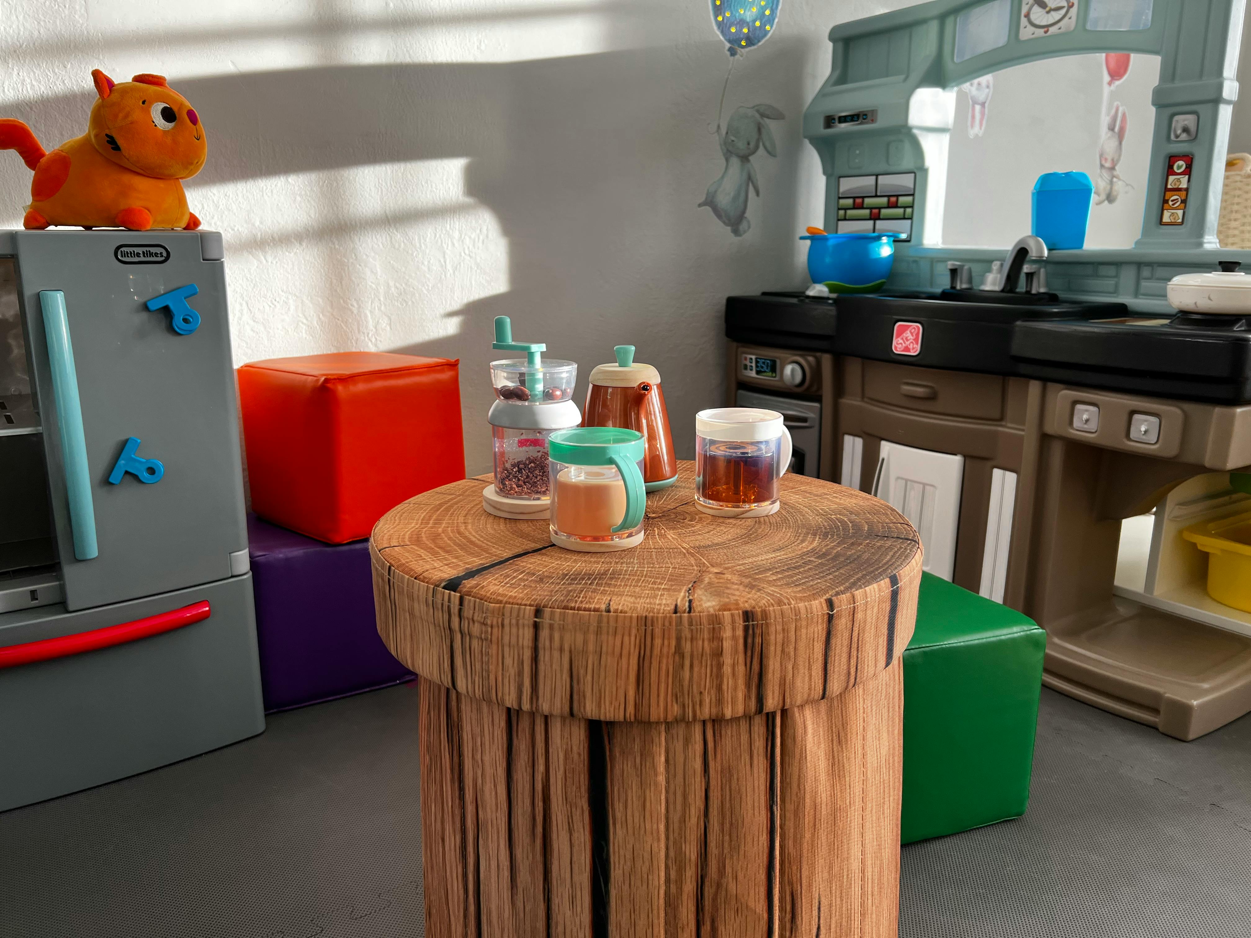 Toy kitchen with a wooden table and drinks