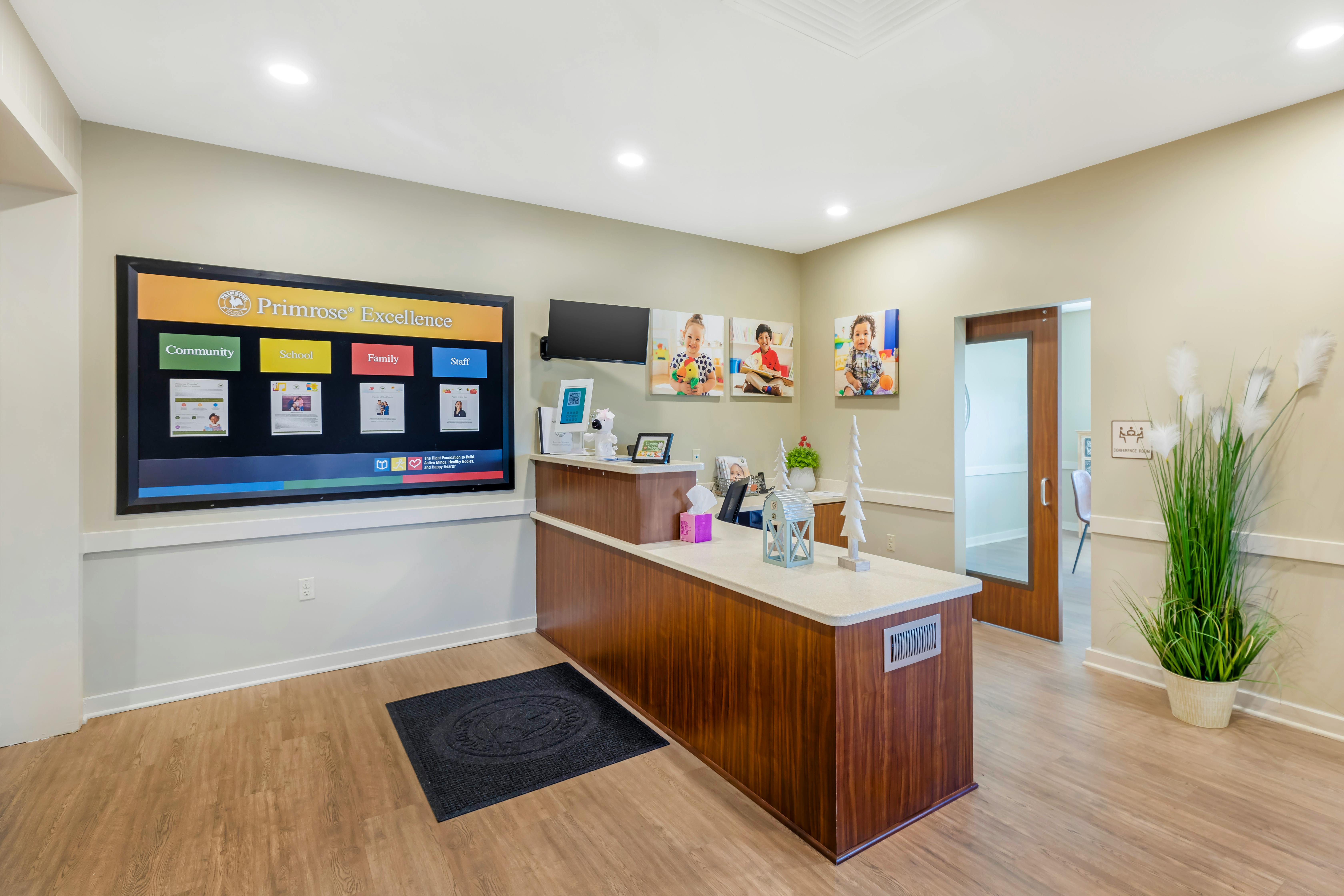 Reception desk with a large screen on the wall