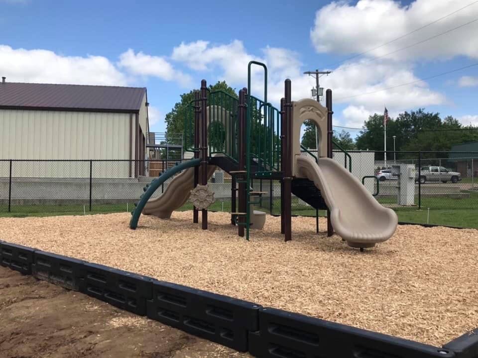 Playground with slides and climbing structures on wood chips