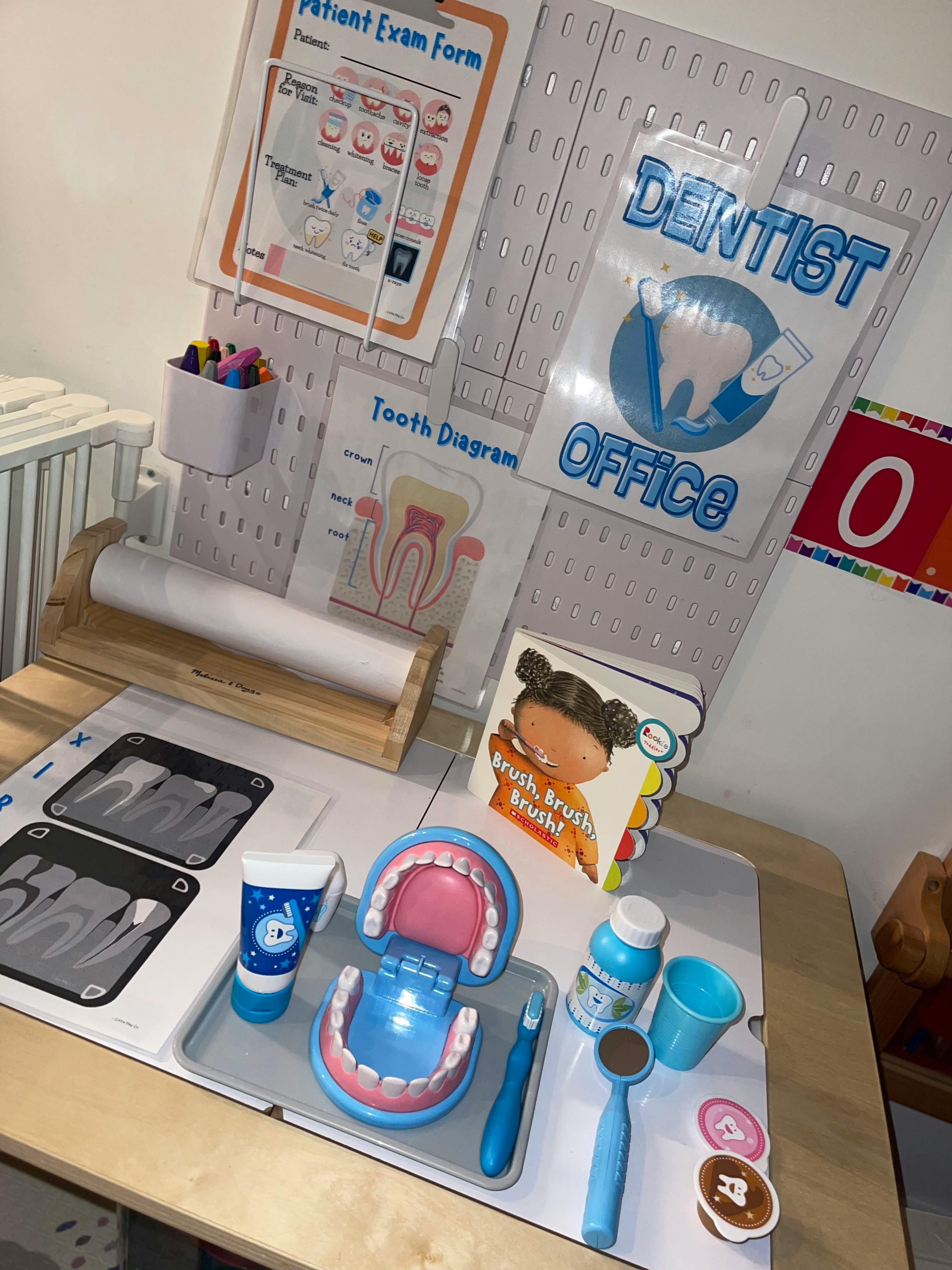 Dentist office play setup with patient form, tooth diagram, and dental tools