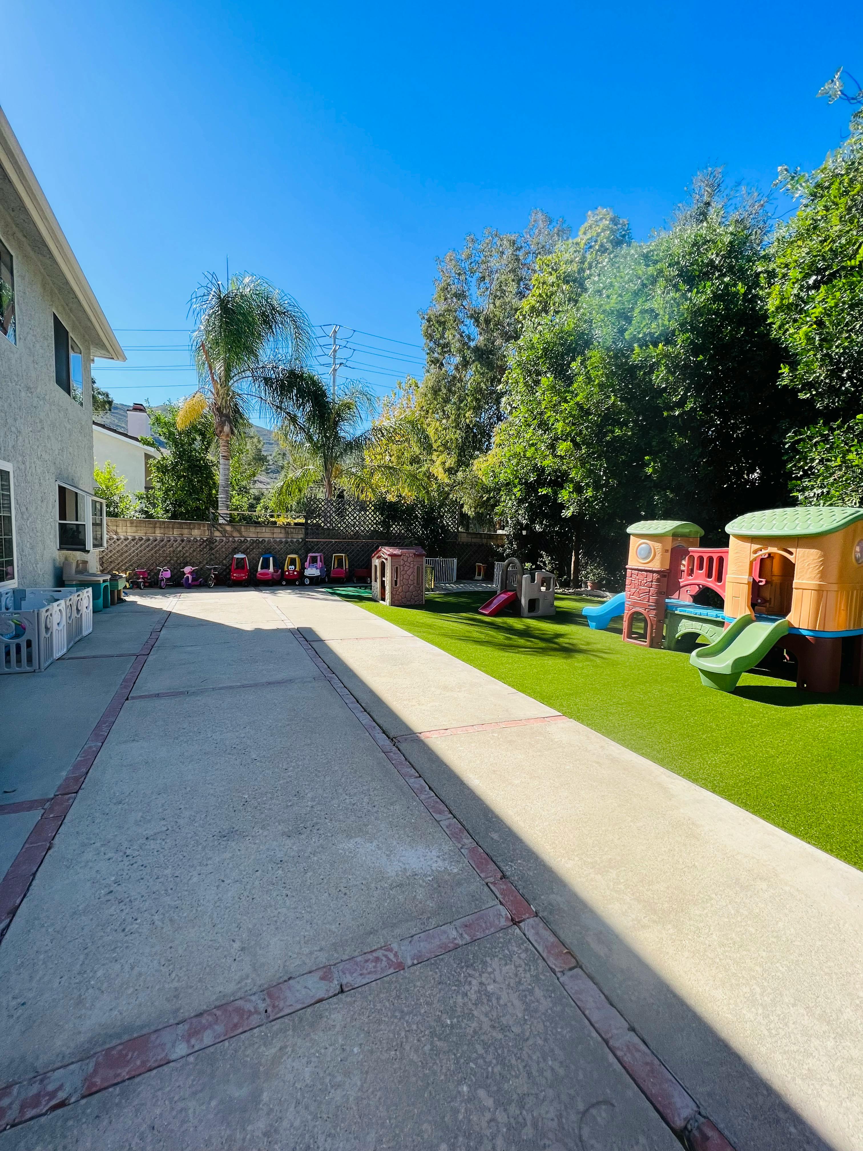 Outdoor playground with artificial turf and play structures