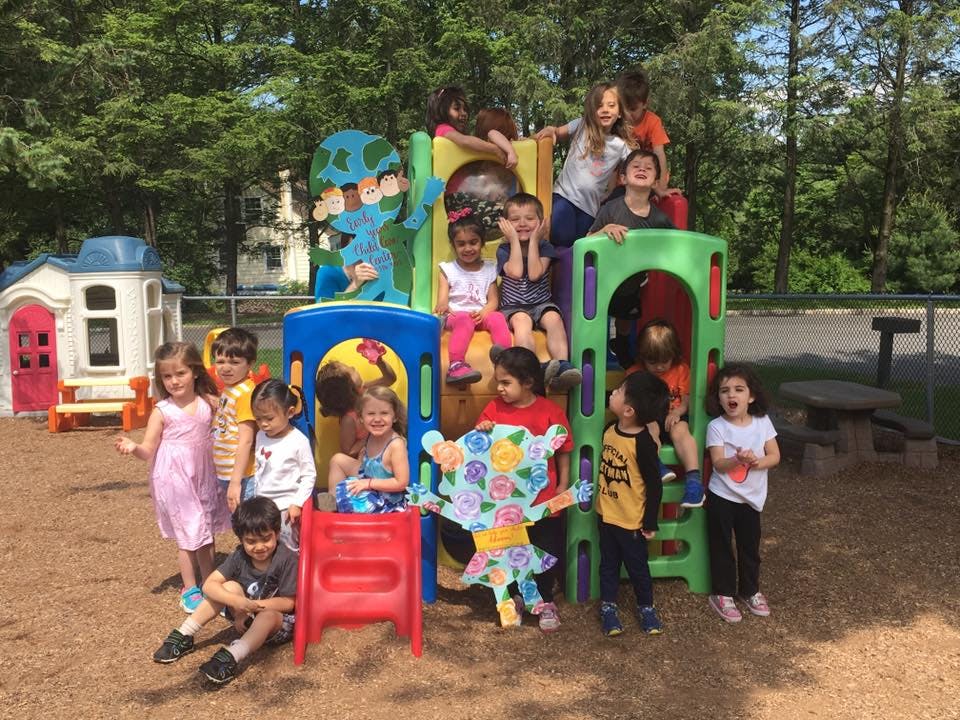 Group of children playing on a colorful outdoor playground structure