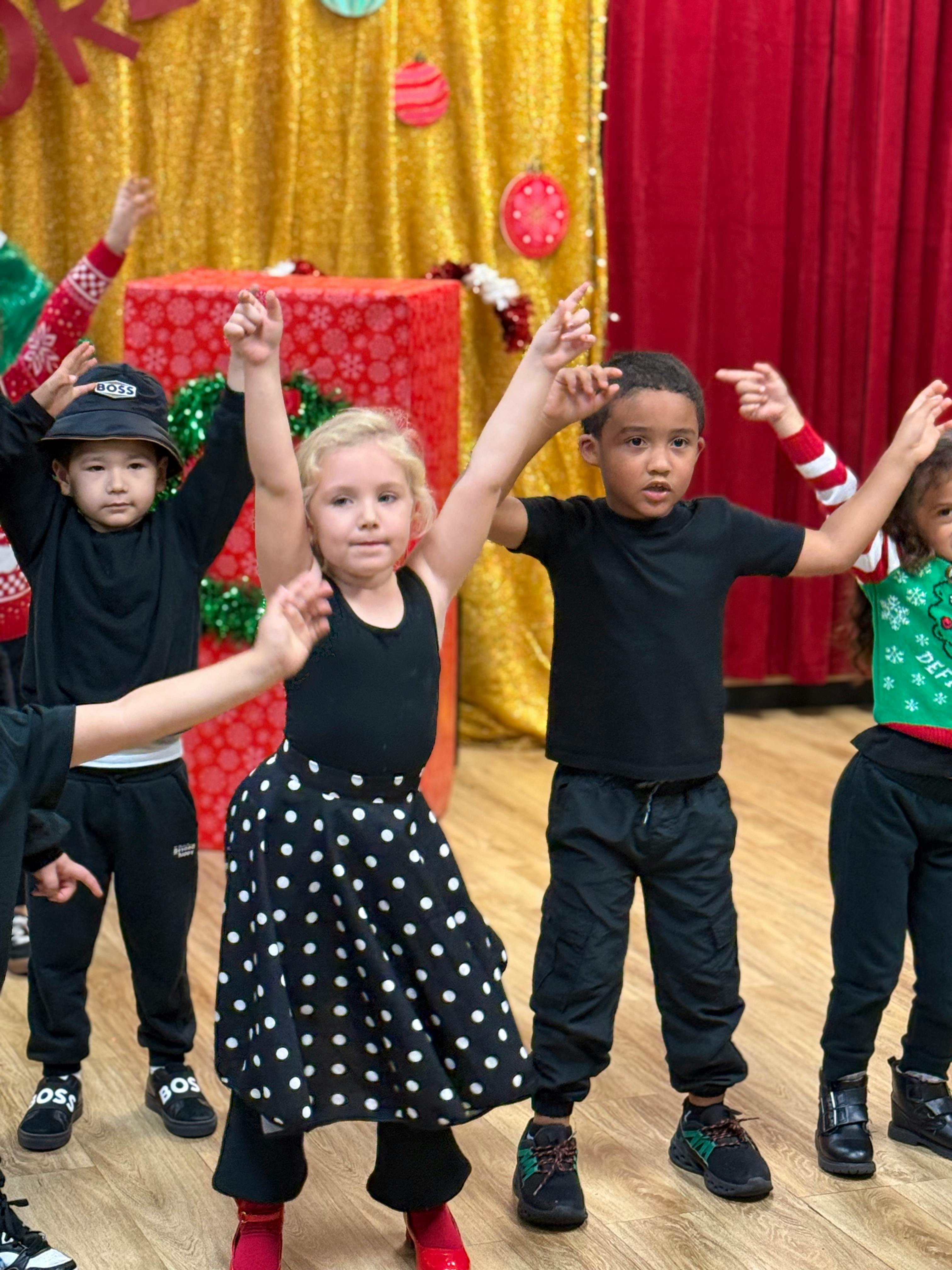 Children dancing with arms raised