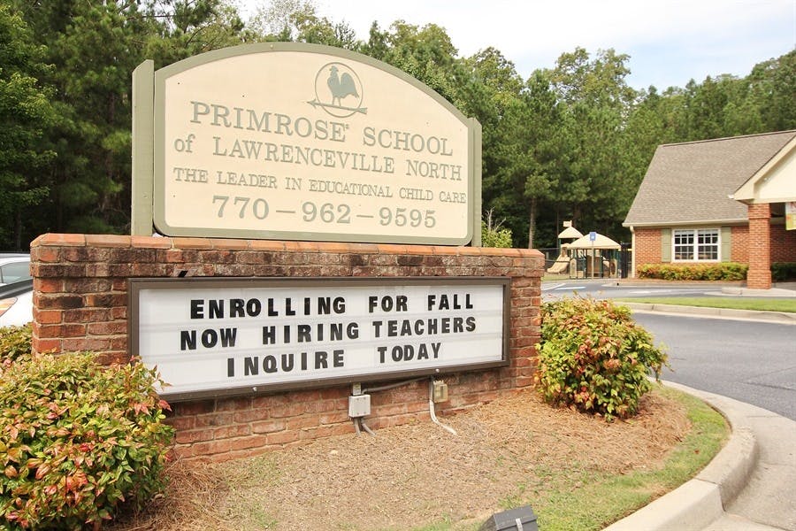 Primrose School sign with "Enrolling for Fall Now Hiring Teachers Inquire Today"