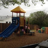Playground with a blue slide and yellow roof structure