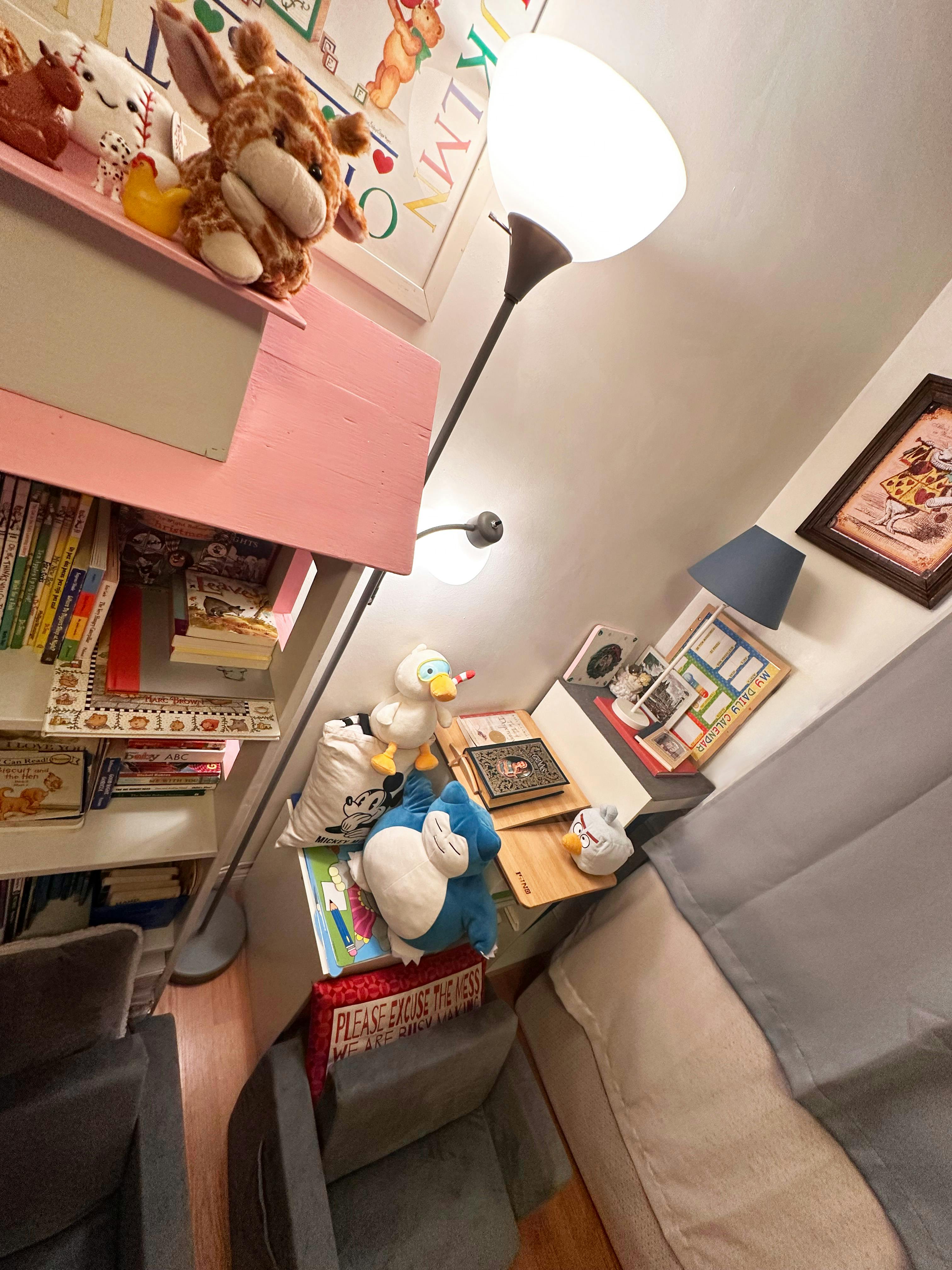 Plush toys and books arranged on shelves and furniture in a child room