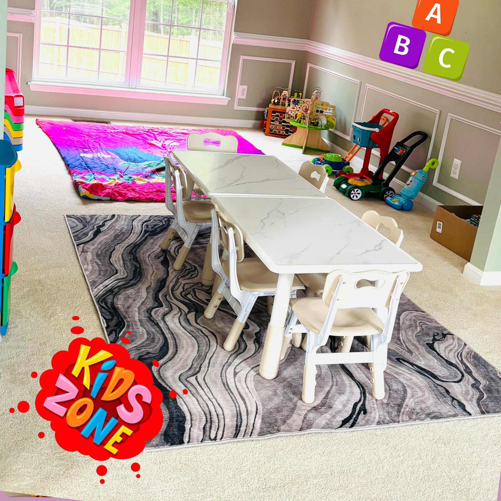 Kids' play area with tables, chairs, toys, and a colorful sleeping bag