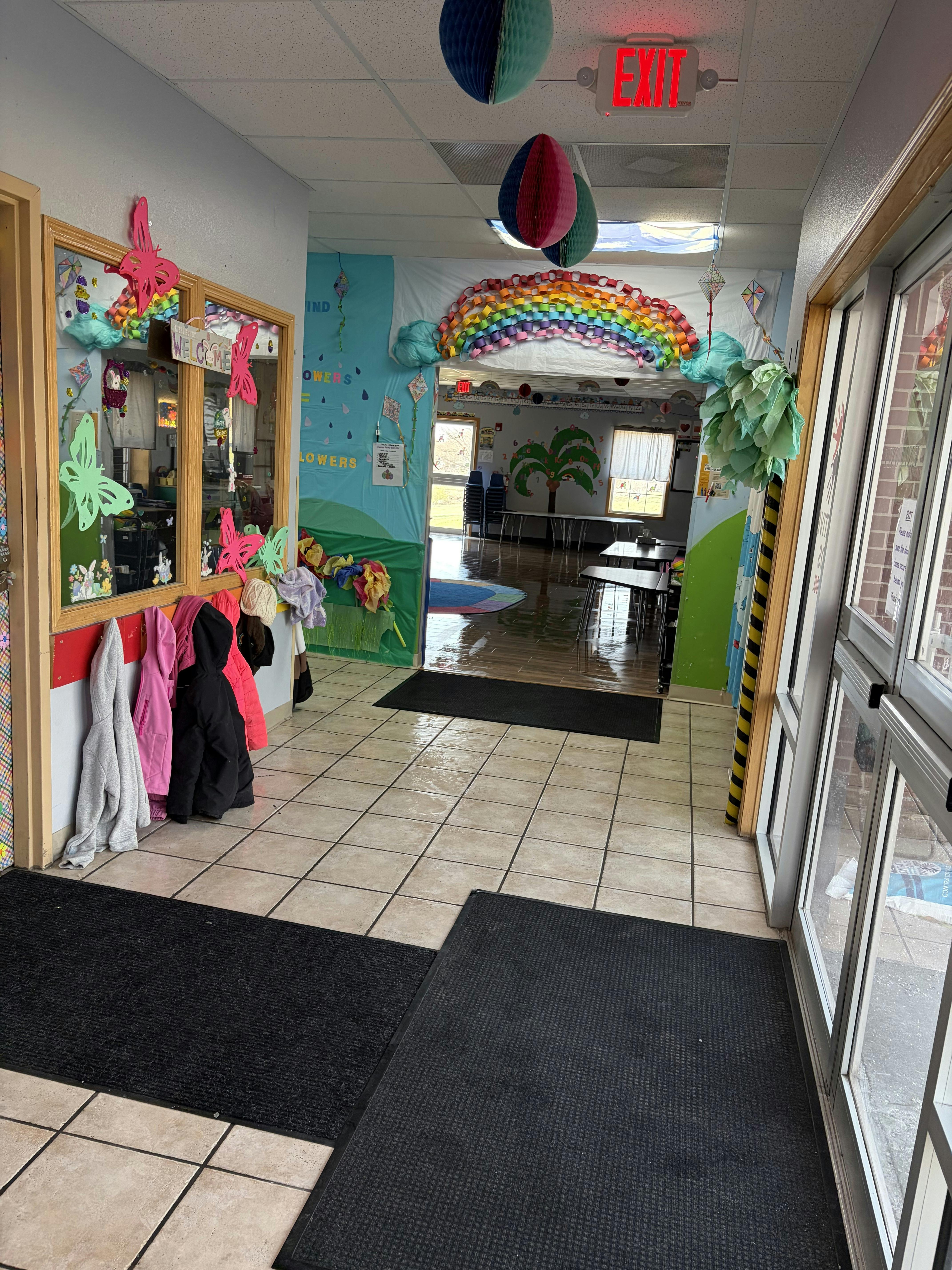 Hallway decorated with colorful paper ornaments and a "WELCOME" sign