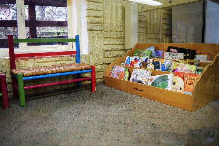 Colorful bench and wooden book display in a room