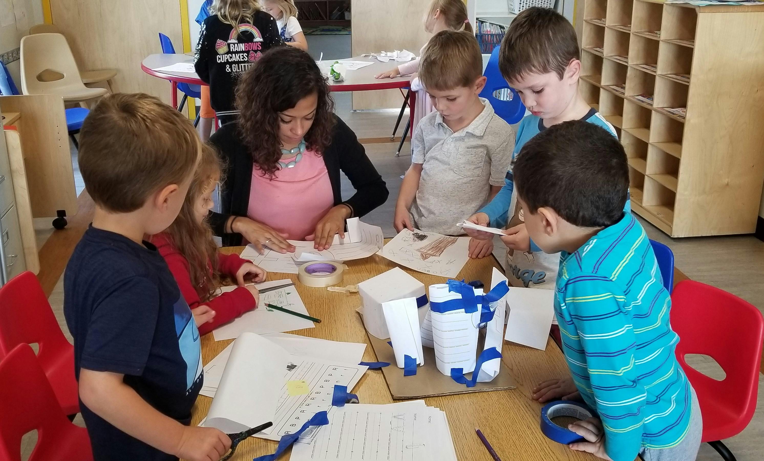 Adult and children working on crafts at a table