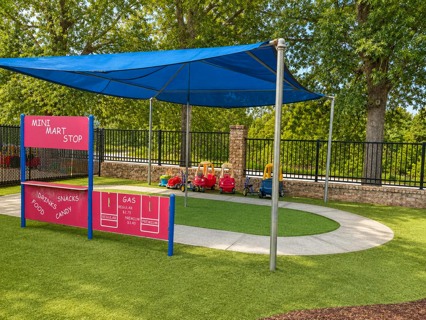 Playground area designed as a miniature gas station with toy cars