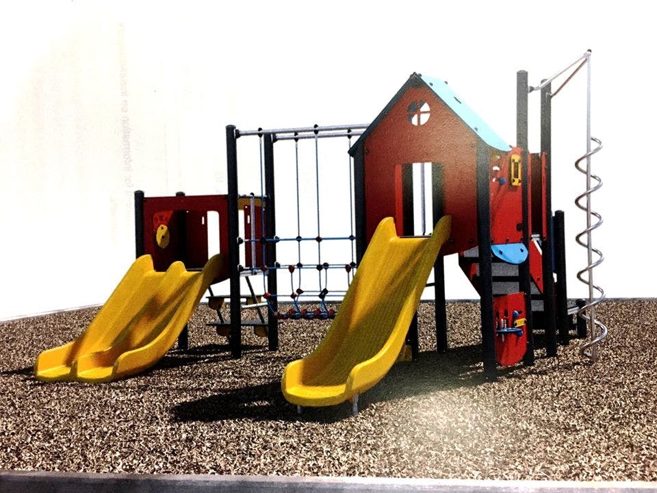 Playground structure with multiple slides and climbing elements