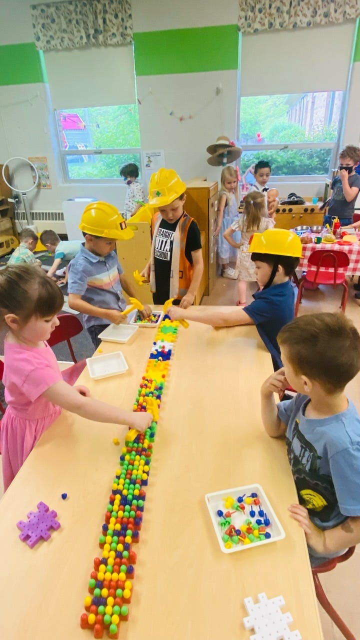 Children playing with colorful building blocks at a table