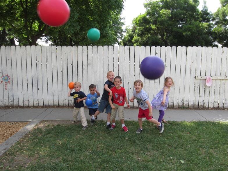 Children playing with large balloons outdoors