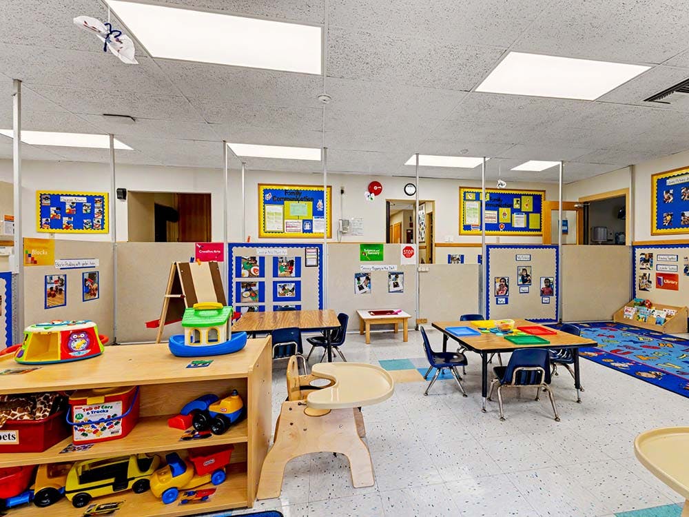 Classroom with tables, chairs, and play equipment for young children