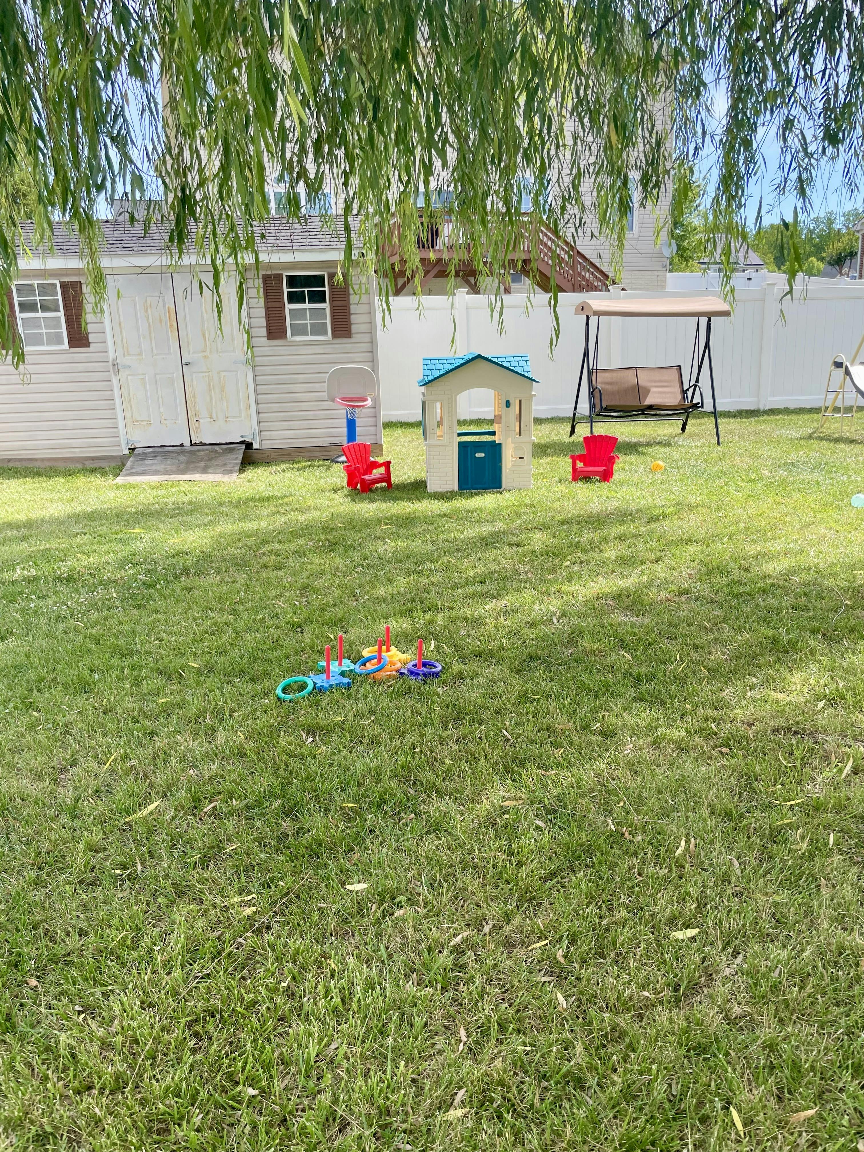 Plastic playhouse and ring toss game on a residential lawn