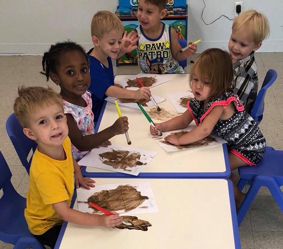Group of children painting at a table