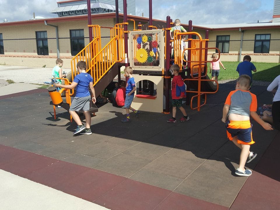 Children playing on a playground structure