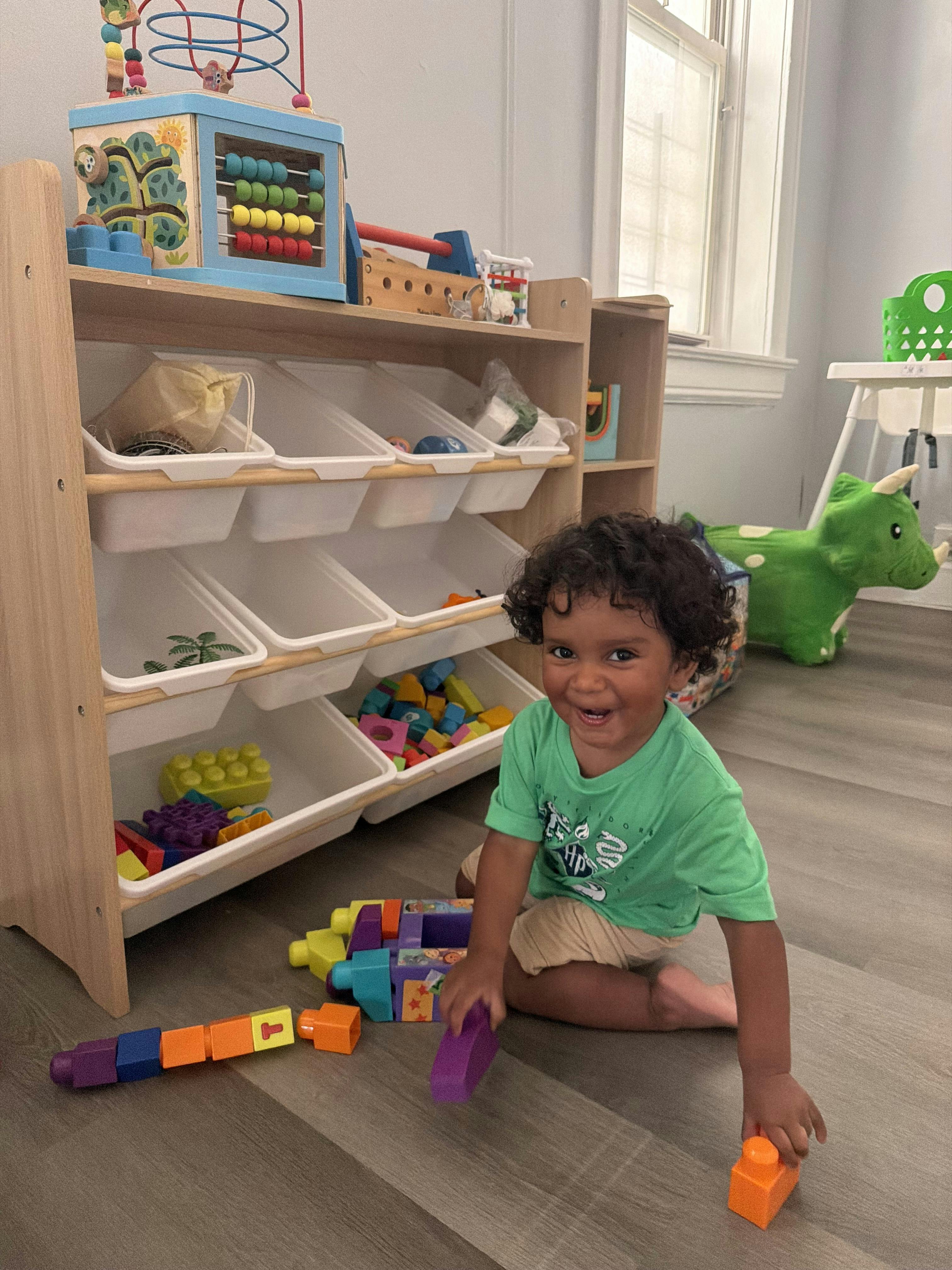 Child sitting on the floor playing with colorful blocks